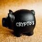 Black piggy bank labeled 'Crypto's' against a sparkling gold backdrop, symbolizing digital investment savings.